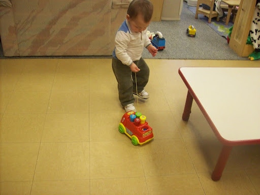 child with shape sorter toy truck